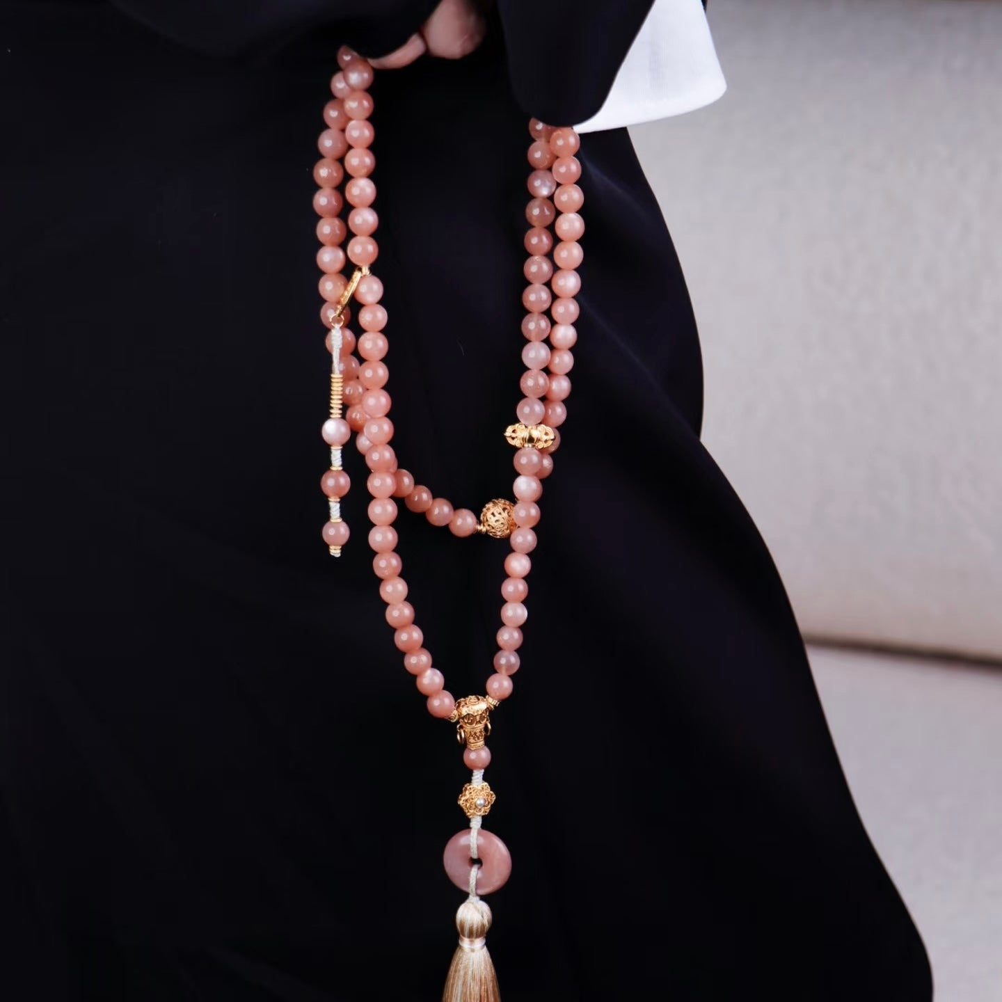 Model presenting the sunstone prayer beads as an elegant gift for conveying Zen blessings and sincere wishes.