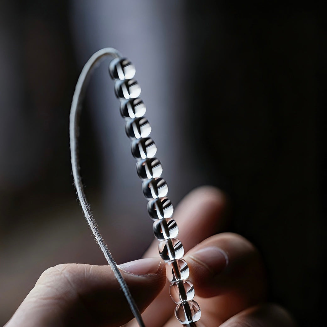 Luxury 2026 fashion staple clear quartz bracelet on a minimalist marble tray.