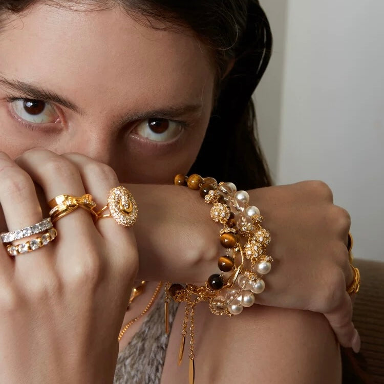 A model showcasing a stack of three gemstone bracelets with 24K gold vermeil.