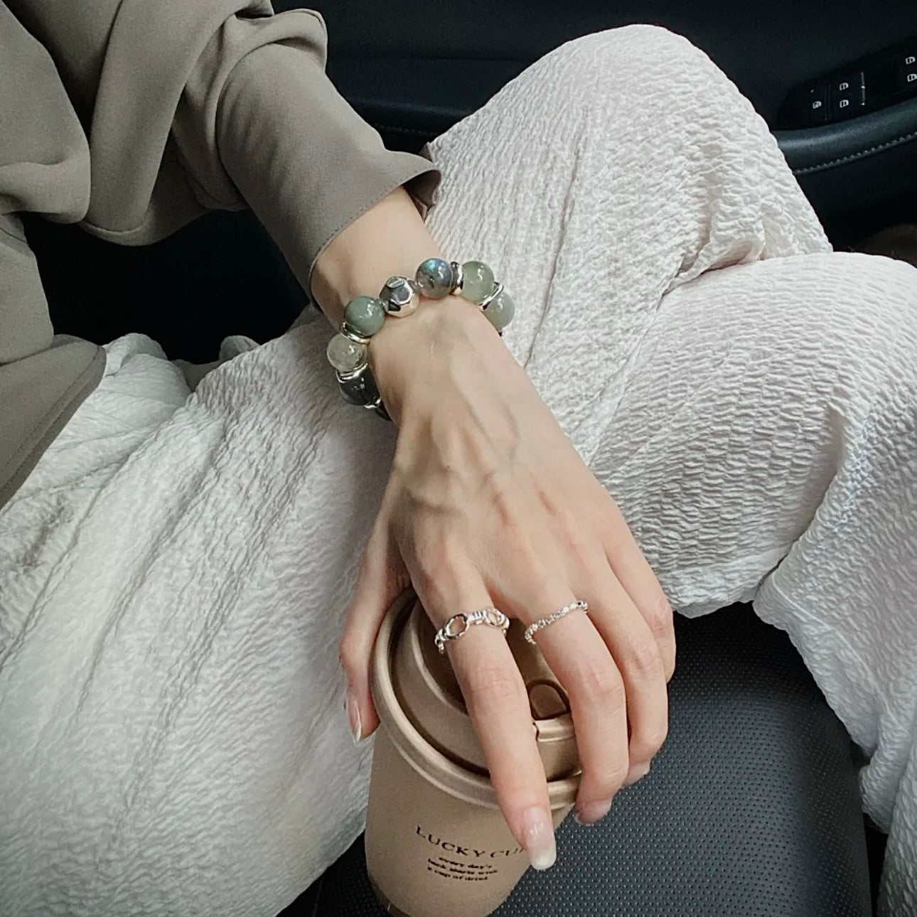 Natural Moonstone and Green Rutile bracelet paired with a neutral wardrobe, showcasing versatile crystal jewelry styling.