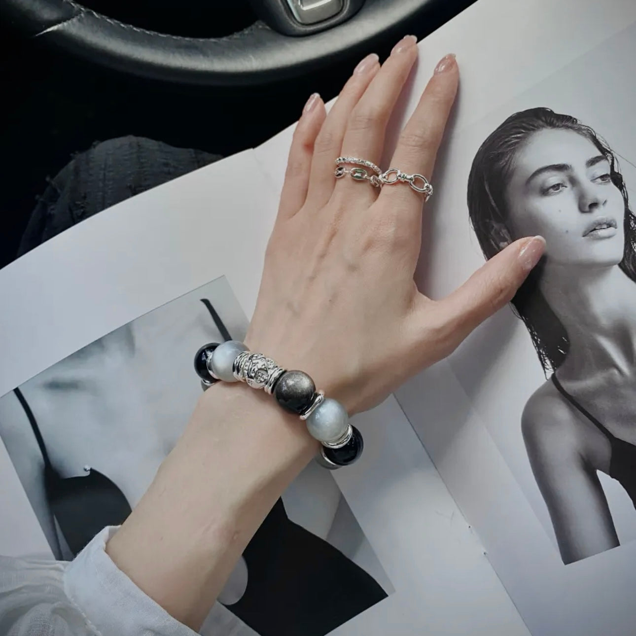 Hand model wearing a Moonstone and Silver Obsidian bracelet styled for everyday fashion, minimalist wardrobes, and modern gemstone jewelry collections.