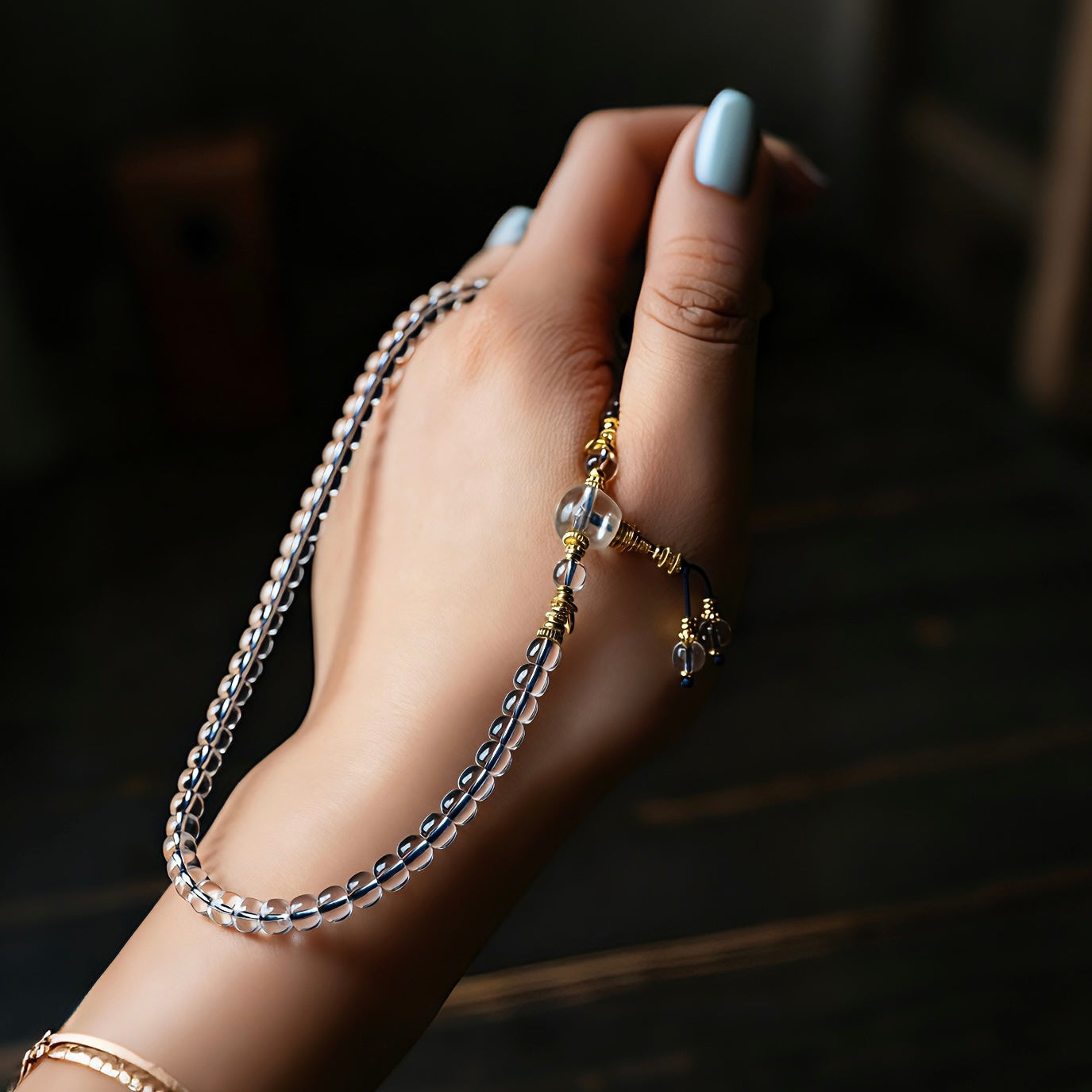 The 6mm crystal mala wrapped multiple times around a hand, highlighting its versatile wear.
