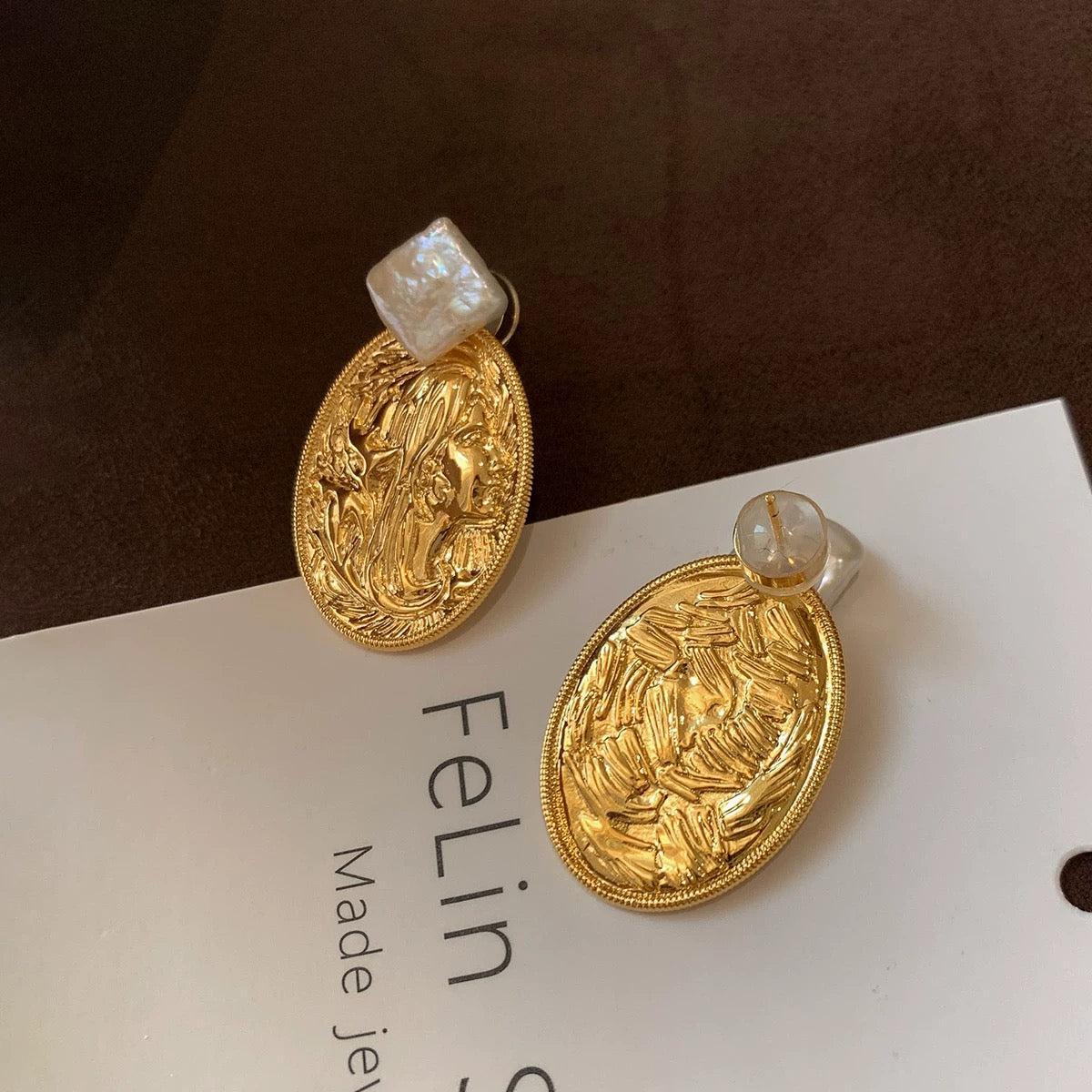 Pure copper medallion earrings with embossed feminine silhouette and baroque pearl studs, vintage aesthetic.