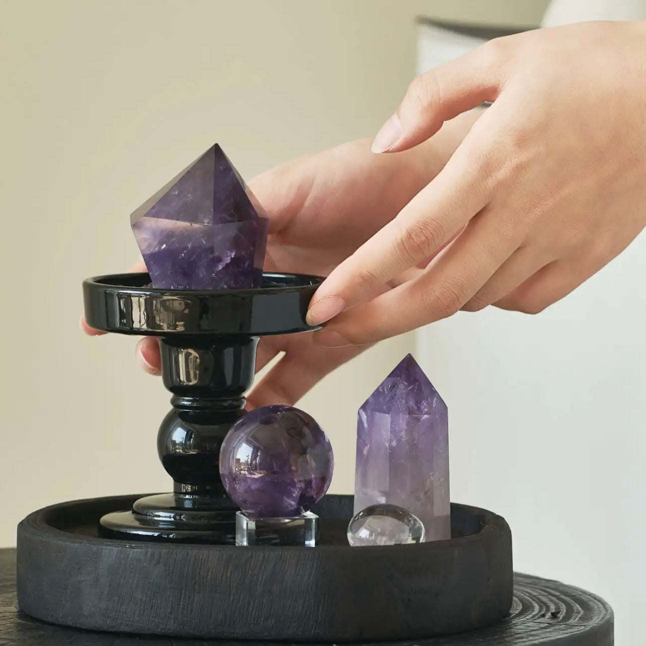 A person holding a 5-6cm natural amethyst point in hand, showing its rich purple color and unique spiritual energy.