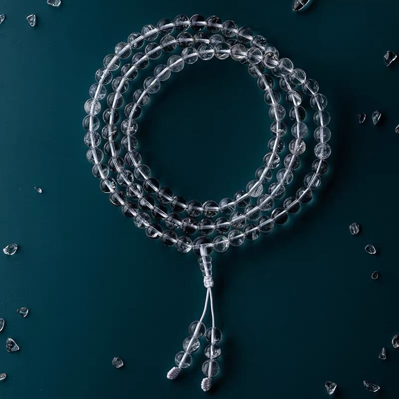 Close-up details of transparent clear quartz crystal meditation necklace