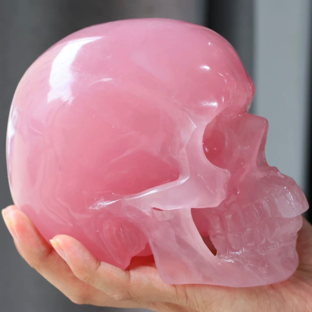 Both hands holding Natural Rose Quartz Skull Carving to show size and weight scale of the 3kg crystal piece