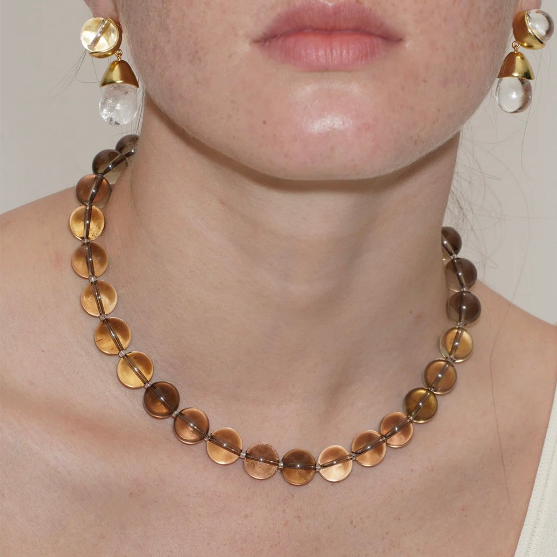 Close-up details of natural smoky quartz crystal necklace beads