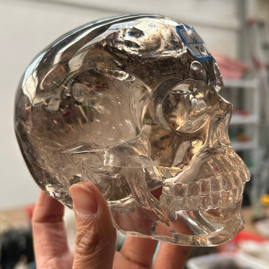 Natural Smoky Quartz Skull Carving front view showing lifelike facial contours and deep smoky translucence
