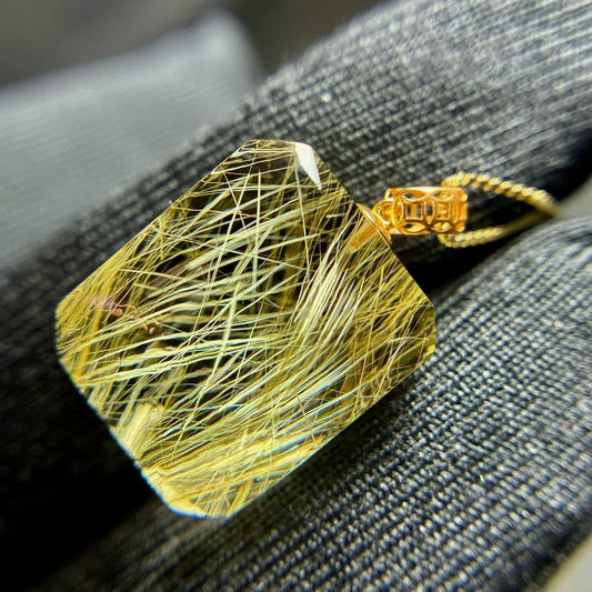 Macro photography of the dense golden rutile inclusions, highlighting the rare "Venus Hair" effect.