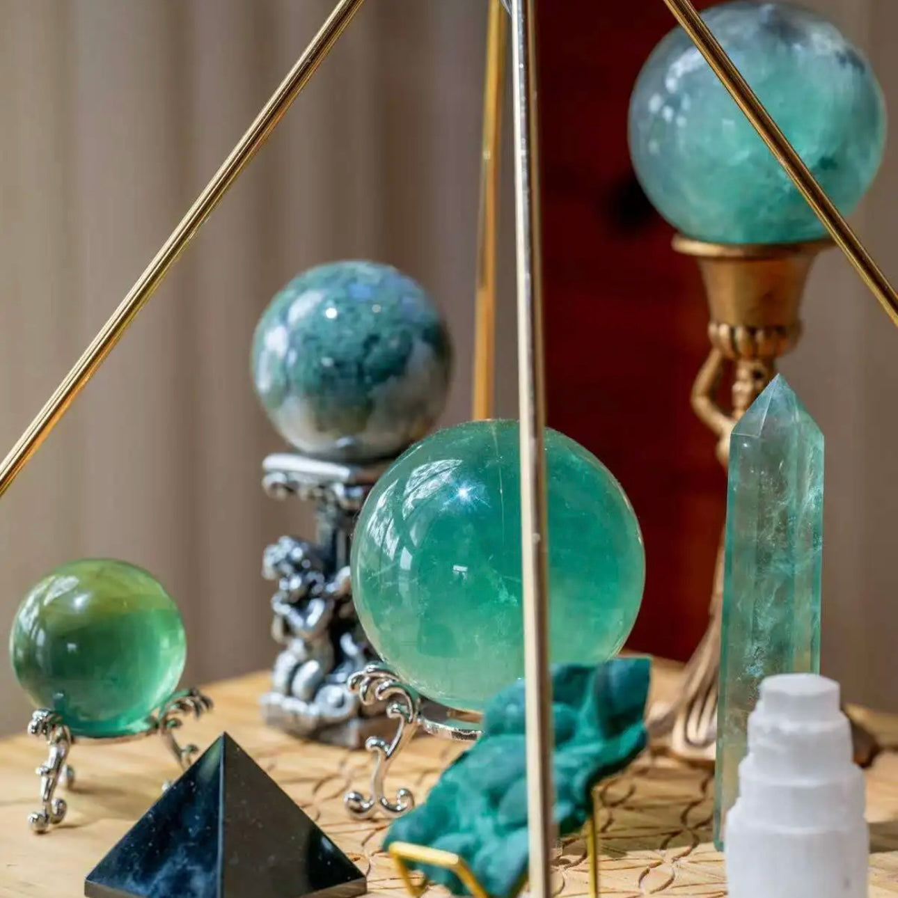 Detail of an obsidian pyramid and fluorite eggs designed for aura shielding and grounding.