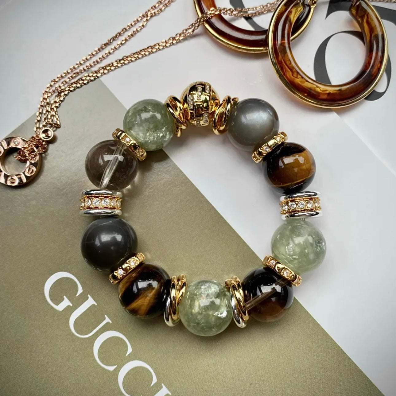 Flatlay of old money chunky natural stone bracelet — green aventurine, tiger's eye, moonstone and smoky quartz beads with 24K gold-plated titanium hardware, Gentle Crystals
