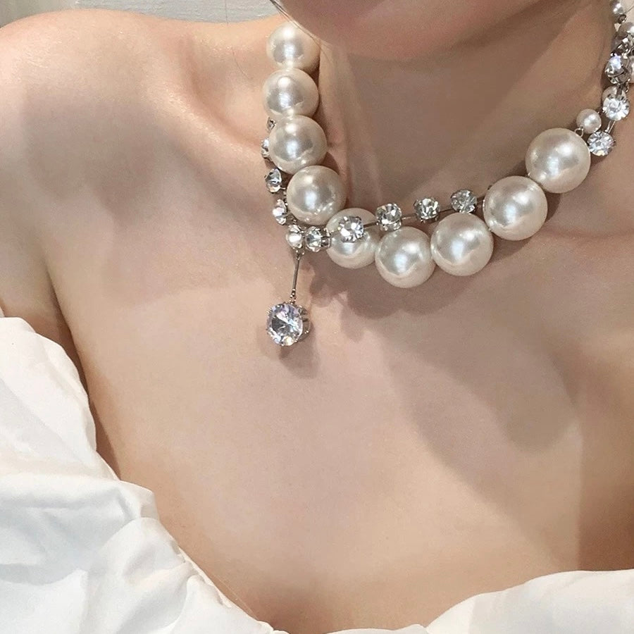 Luxe oversized 28mm faux pearl necklace on model, showcasing a bold and elegant high-fashion look.