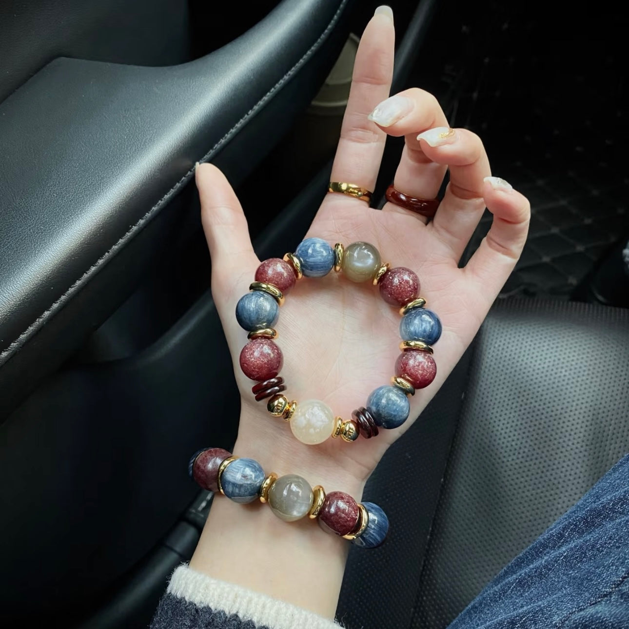 Realm Crimson Glow crystal bracelet on model wrist - Dragon Scale Blue Celestite Strawberry Quartz Blood Amber 14mm Gentle Crystals