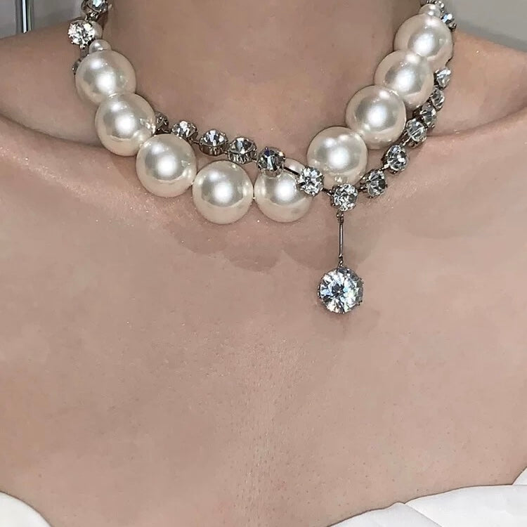 Styling the large pearl necklace with formal evening wear for a sophisticated, upscale vibe.