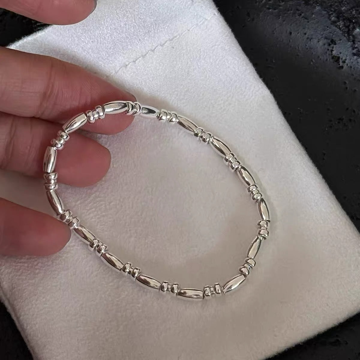 S925 sterling silver rice bead bracelet flat lay on neutral surface — 3mm delicate layering bracelet for minimalist fine jewellery styling