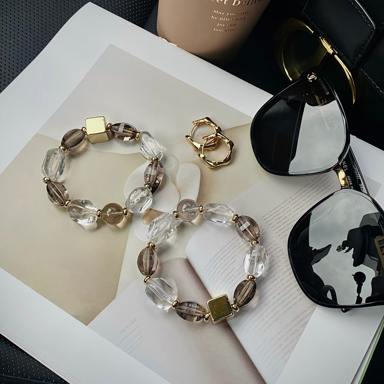 Close-up detail of natural Smoky Quartz and Clear Quartz freeform beads with premium titanium steel hardware.