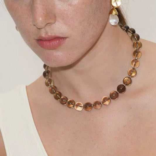 Model wearing elegant smoky quartz crystal necklace with minimalist styling