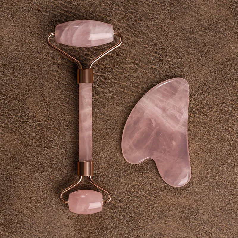 Close-up of the mild and smooth texture of the natural rose quartz facial massage tools.