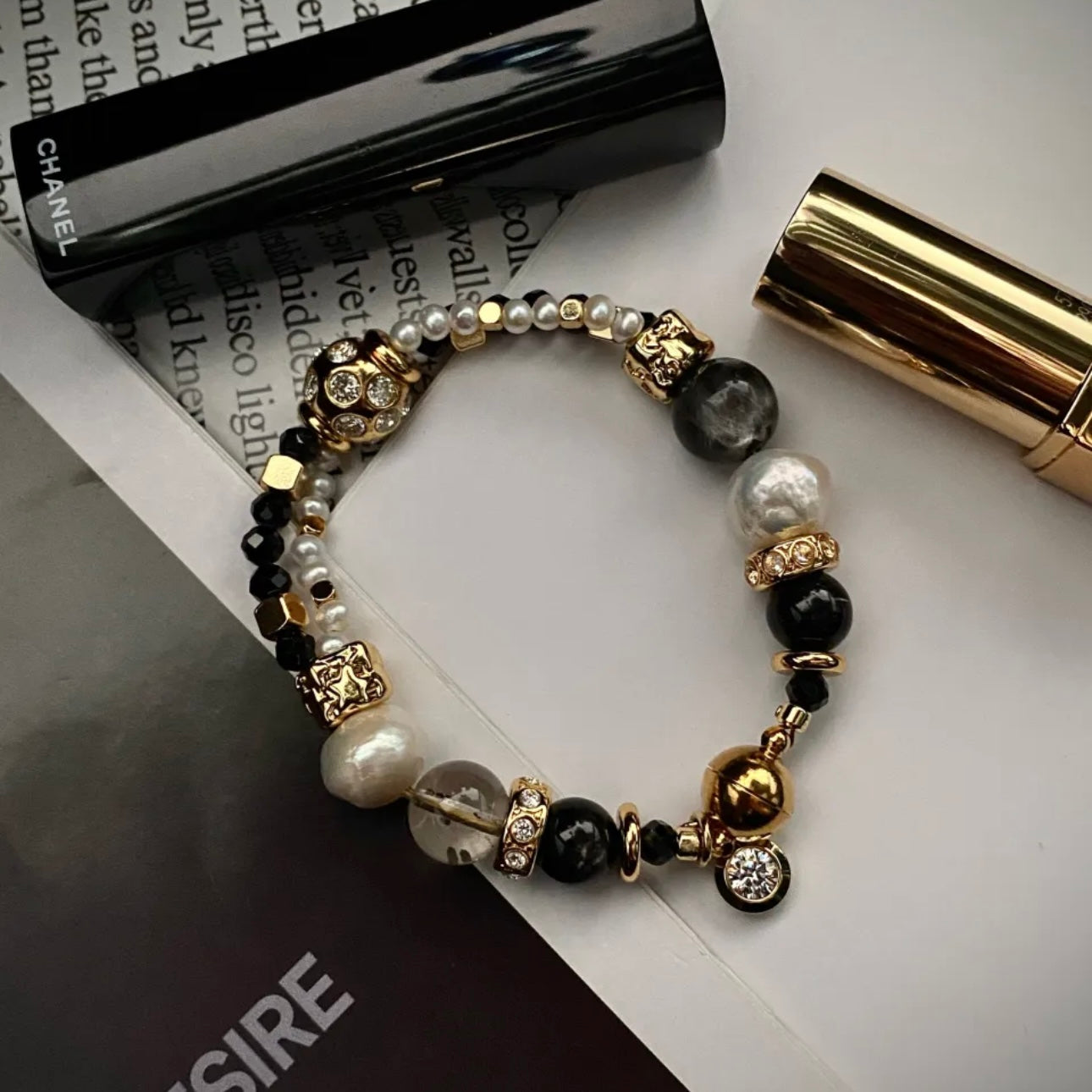 Starlight Aura Quartz and Freshwater Pearl statement bracelet with 24K gold-plated titanium steel hardware, flat lay on neutral background