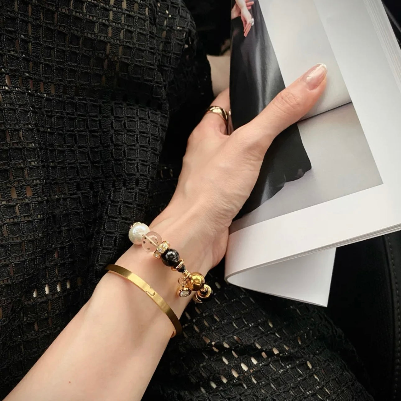 Starlight Aura Quartz and Pearl bracelet worn on wrist, black and gold luxury jewelry styling, elegant everyday accessory