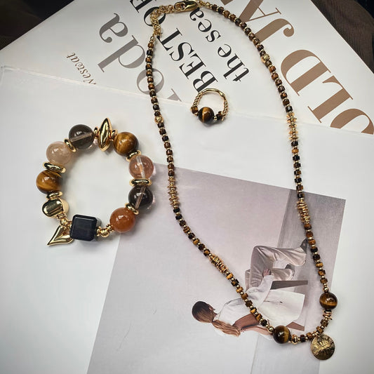 iger's Eye Old Money crystal jewelry set flatlay - bracelet necklace ring rutilated quartz obsidian Gentle Crystals