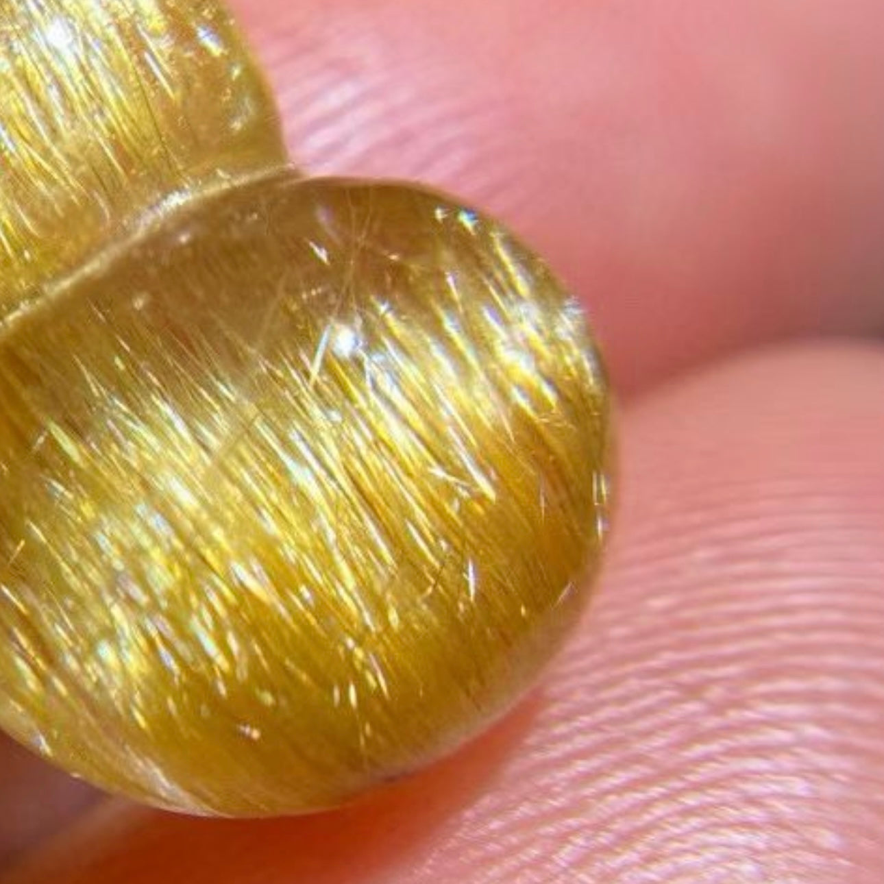 Backlit view of the natural golden rutilated quartz showing transparency and pure inclusions.