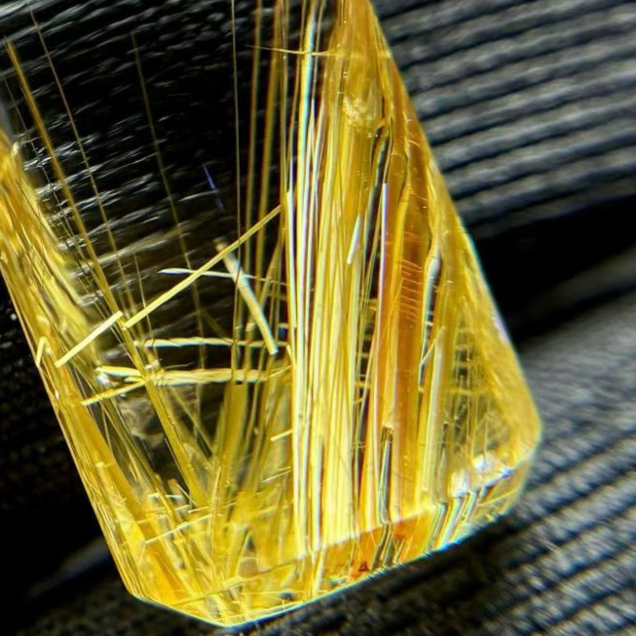 Close-up of natural titanium rutilated quartz showing the transparency and wealth-attracting golden fibers.