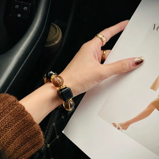 Model wrist wearing Twilight Narrative obsidian cube bracelet - protective black crystal jewelry Gentle Crystals