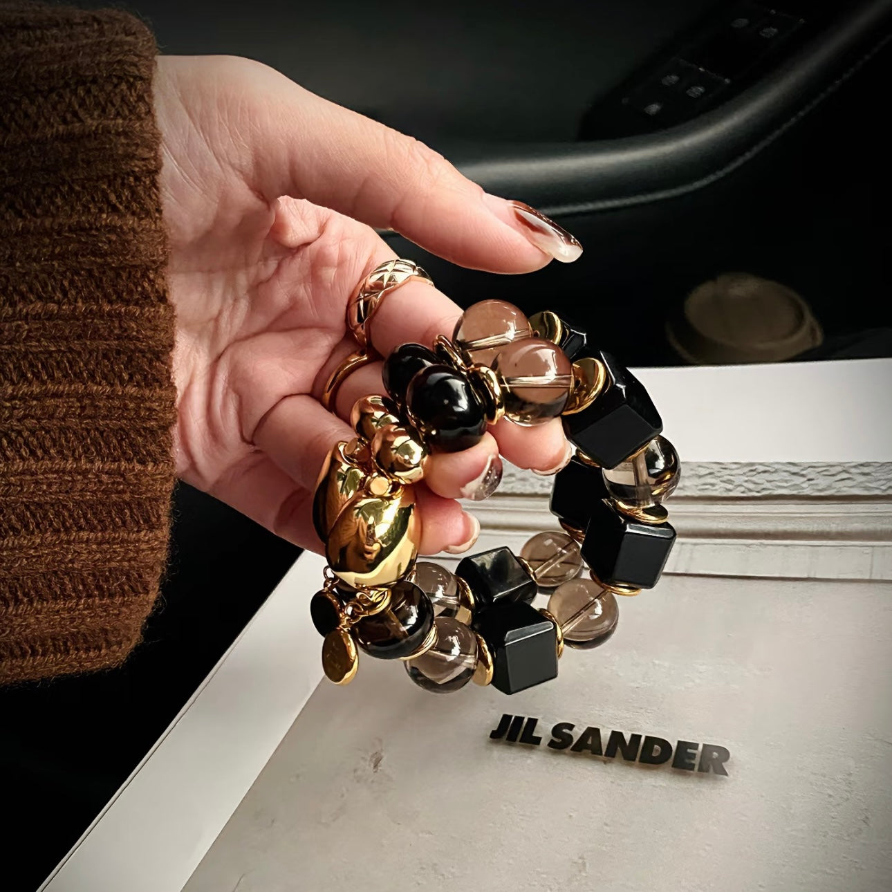 Model hand with Twilight Narrative smoky quartz obsidian bracelet - old money aesthetic luxury crystal Gentle Crystals