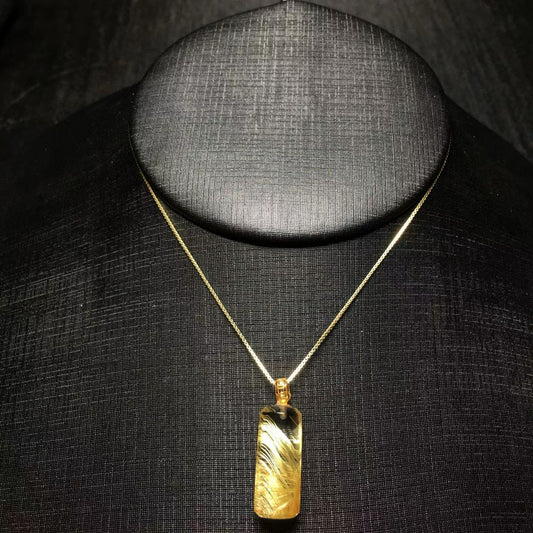 The exact 1 of 1 natural titanium crystal cylinder pendant with unique golden rutiles.