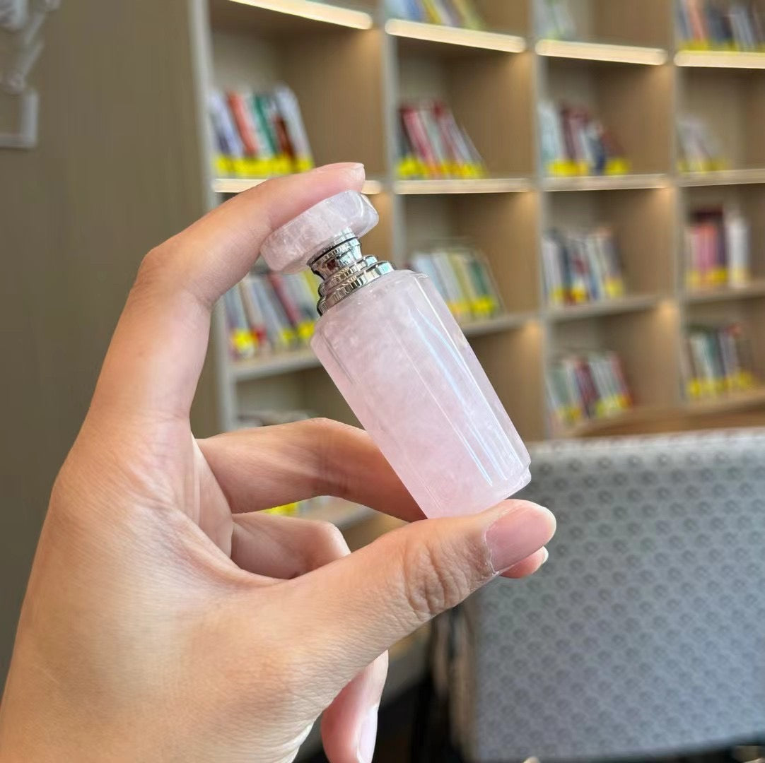 A collection of various rose quartz and clear quartz bottles in random shapes and styles.