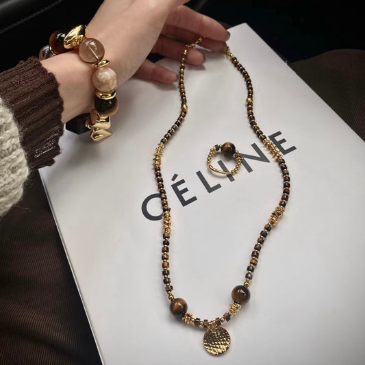 Model styled in vintage brown Old Money crystal jewelry set - Tiger's Eye obsidian bracelet necklace 2026 Gentle Crystals