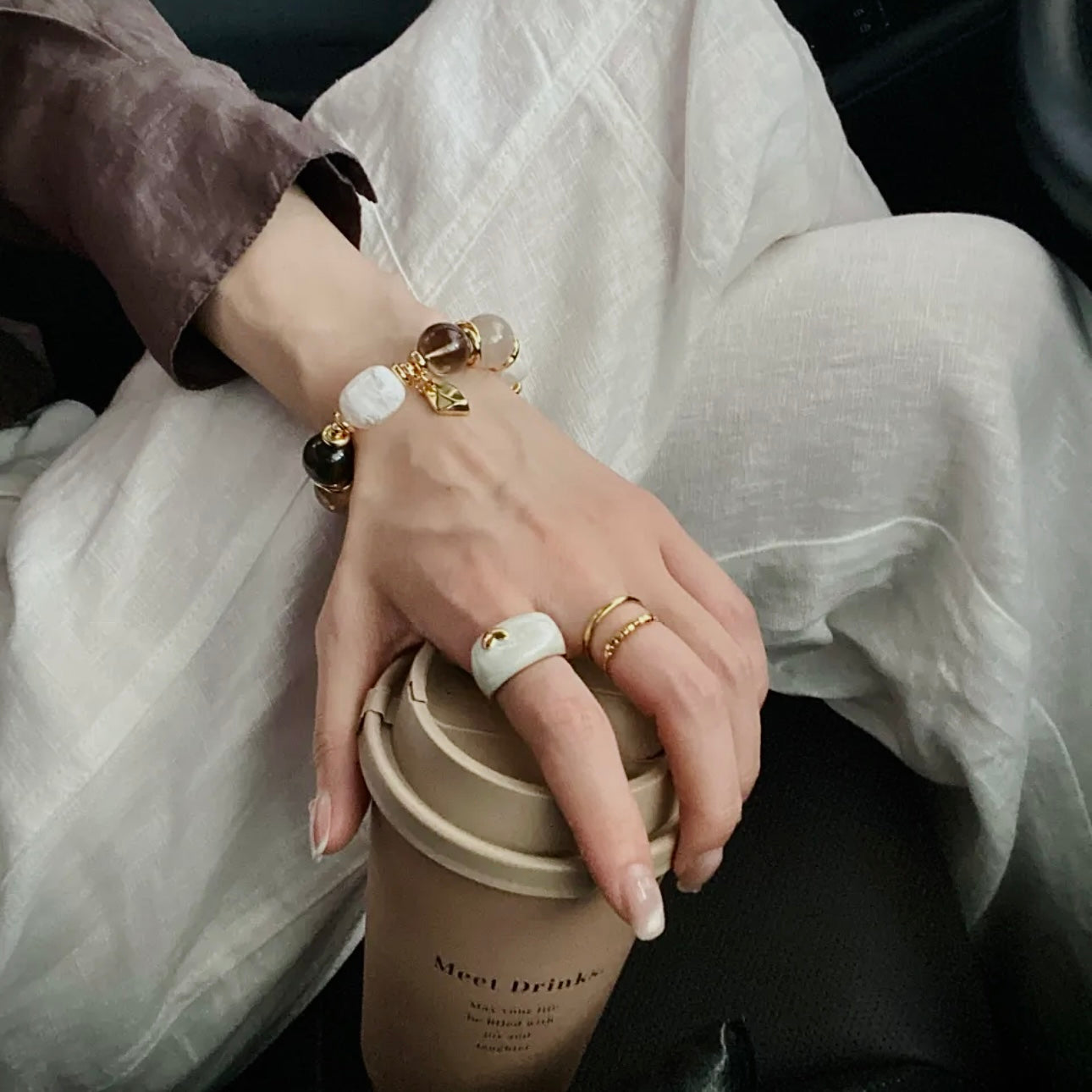 Vintage smoky quartz bracelet worn on wrist, styled with neutral wardrobe