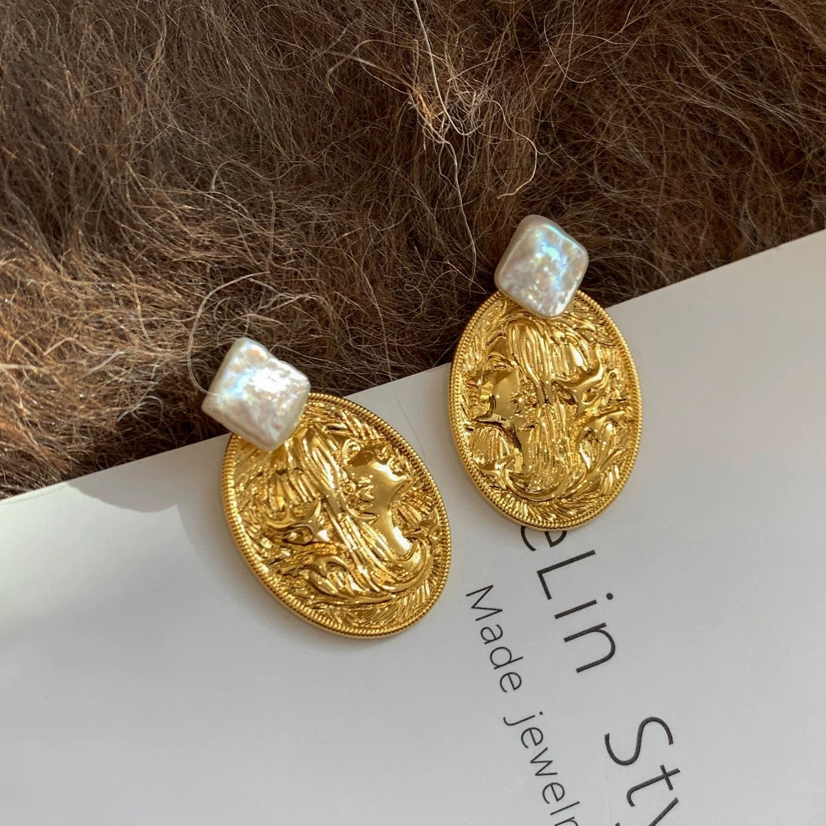 Artisan copper and pearl earrings styled in natural light, representing the modern vintage collection by Gentle Crystals.