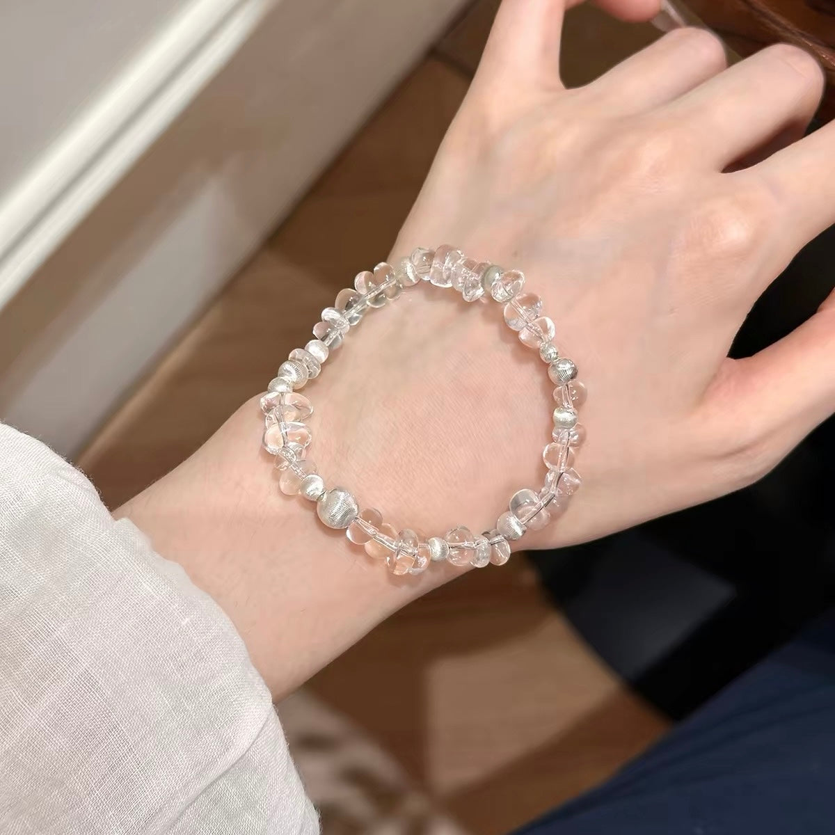 Natural white freeform clear quartz bracelet with organic-shaped crystal beads and silver-tone accents, styled for everyday wear.