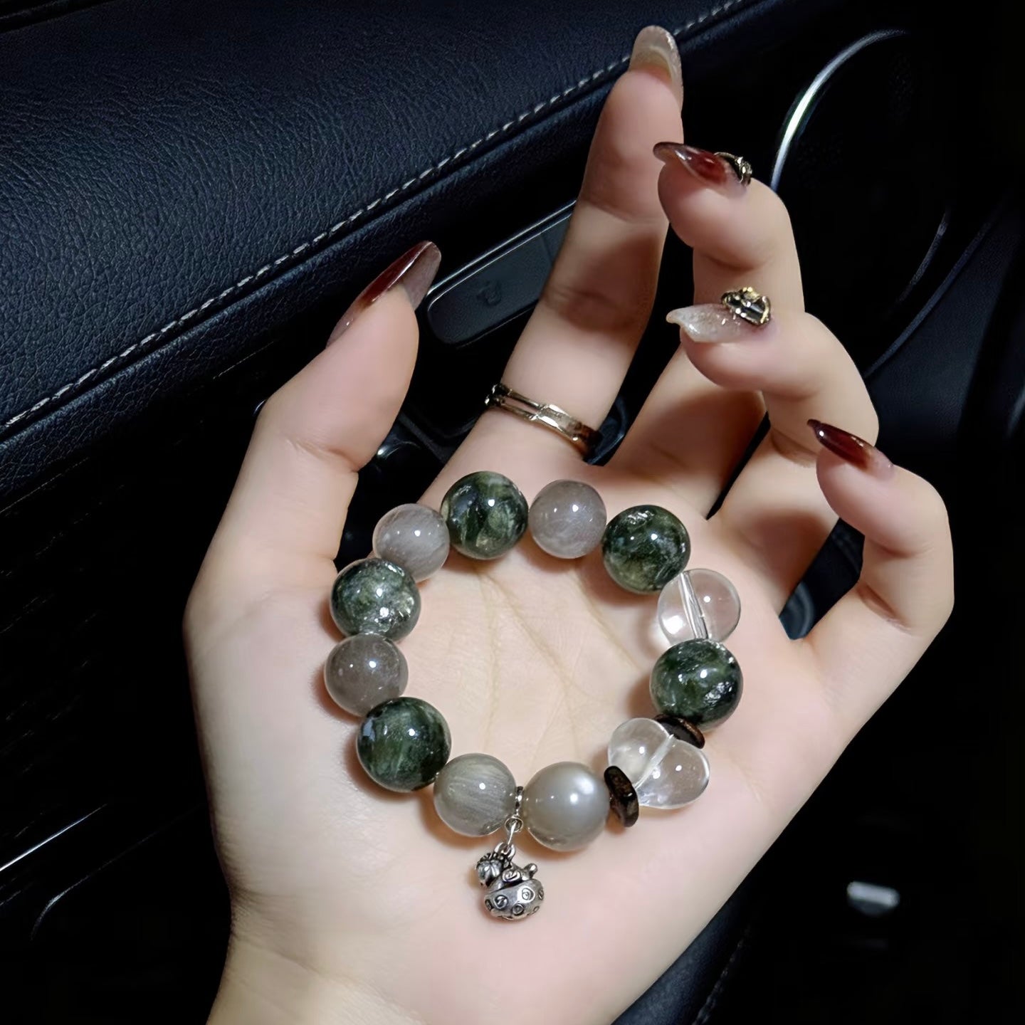 High-end custom 15mm Green Phantom bracelet with 925 sterling silver charms on a palm.