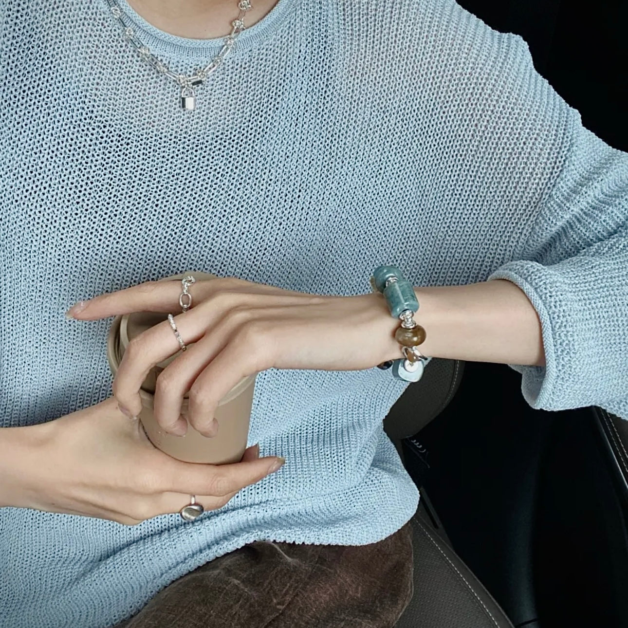 Xinjiang Hetian jade and aquamarine bracelet styled with earth-tone outfit — natural stone bracelet layering with cool-tone and warm-tone wardrobe pairing