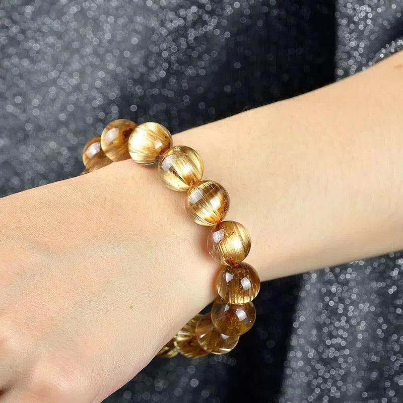 Model wearing Zen Fortune Key Golden Rutilated Quartz bracelet on wrist, showing fit and scale