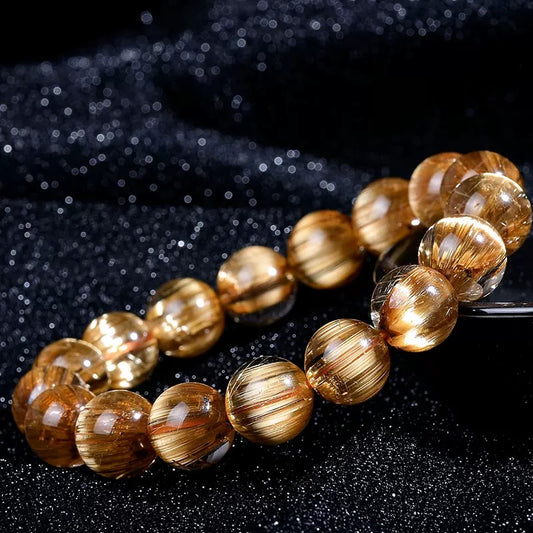 Zen Fortune Key bracelet featuring 12mm Golden Rutilated Quartz beads on a white marble surface