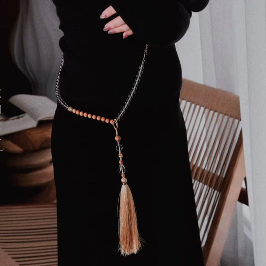 Model wearing the Clear Quartz and Sandalwood prayer beads over a black blazer, showcasing modern Zen office style.